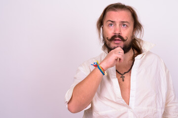 Bearded man with mustache and long hair against white background
