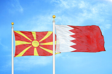 North Macedonia and Bahrain two flags on flagpoles and blue sky