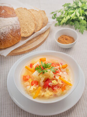 Cabbage soup, bread, parsley and spice on the table