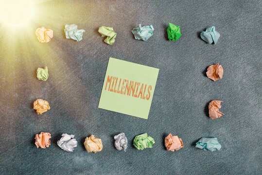 Text sign showing Millennials. Business photo text an individual reaching young adulthood in the early 21st century Paper accesories with digital smartphone arranged on different background