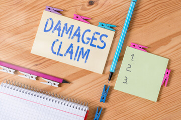Conceptual hand writing showing Damages Claim. Concept meaning seeks to repair the damages or...