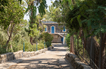 Shady alley leading to the Church of the Apostles located on the shores of the Sea of Galilee, not far from Tiberias city in northern Israel