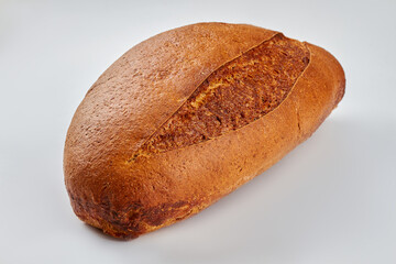 Loaf of fresh bread on white background. Crusty freshly baked bread. Healthy bread recipe.