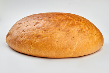 Round loaf of bread on white background. Traditional wheat bread. Food concept.