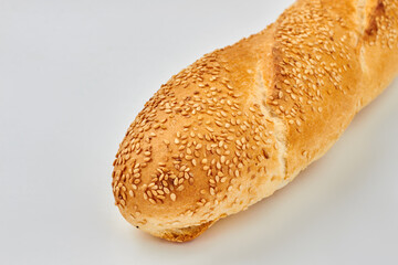 French bread with sesame seeds. Crispy french baguette isolated on white background. Food and bakery concept.