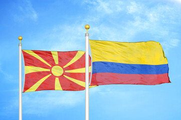 North Macedonia and Colombia two flags on flagpoles and blue sky