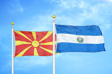 North Macedonia and El Salvador two flags on flagpoles and blue sky