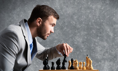 Businessman moving chess figure in chessboard