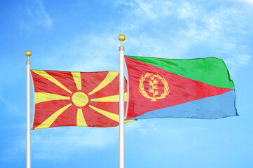 North Macedonia and Eritrea two flags on flagpoles and blue sky
