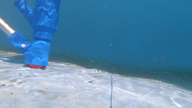 Underwater view of a pool vacuum cleaner on a pool floor