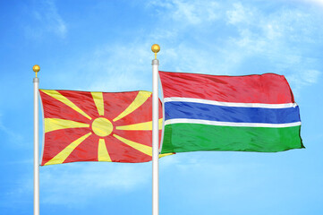 North Macedonia and Gambia two flags on flagpoles and blue sky