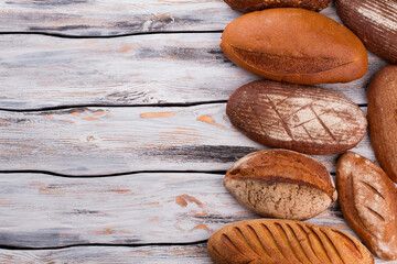 Delicious homemade bread and copy space. Artisan bread on rustic wooden background.