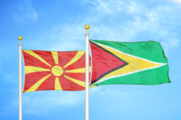 North Macedonia and Guyana two flags on flagpoles and blue sky