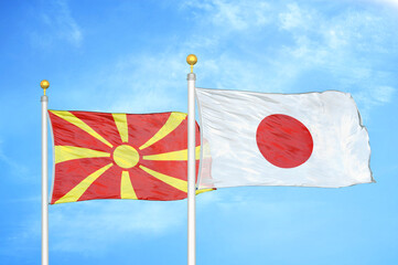 North Macedonia and Japan two flags on flagpoles and blue sky
