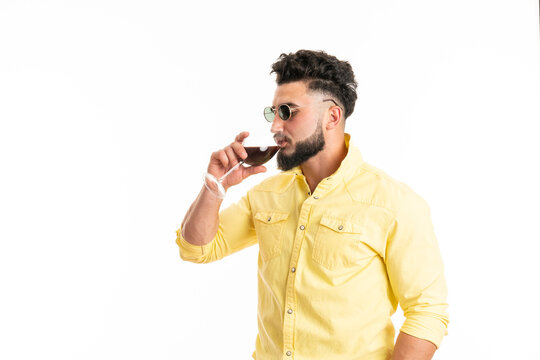 Sommelier, degustator with glass of red wine, winery, male winemaker. Beard man, bearded, sommelier tasting red wine. Man with a glass of wine in his hands