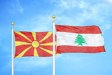North Macedonia and Lebanon two flags on flagpoles and blue sky