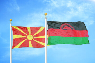 North Macedonia and Malawi two flags on flagpoles and blue sky