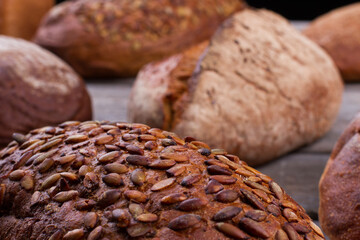 Close up of artisan bread with pumpkin seeds. Whole grain bread close up. Healthy food.