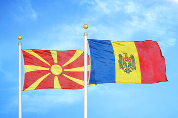 North Macedonia and Moldova two flags on flagpoles and blue sky
