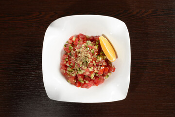 Vegetable salad with tomatoes and cucumbers seasoned with olive oil salad for vegetarians, top view. Photos for restaurant and cafe menus