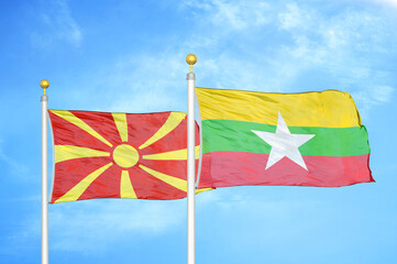 North Macedonia and Myanmar two flags on flagpoles and blue sky
