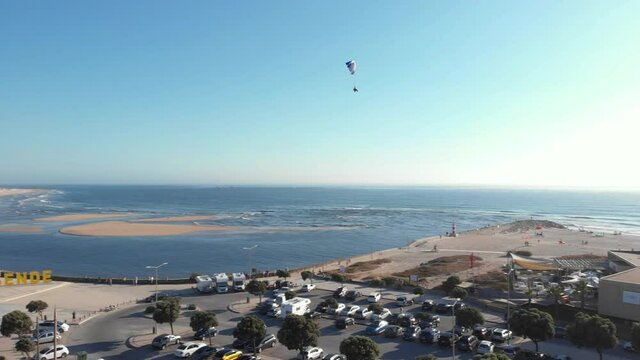 DRONE AERIAL FOOTAGE of Motorized Paraglider / Paramotor flying over Northern Litoral Natural Park in Ofir, Fao, Esposende, Portugal. The two sides of Restinga de Ofir. 