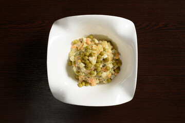 Delicious and tender Olivier salad, top view. Photos for restaurant and cafe menus