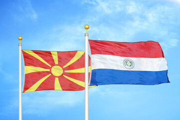 North Macedonia and Paraguay two flags on flagpoles and blue sky