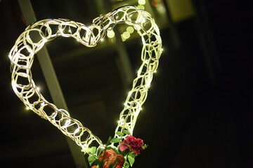 heart decoration with led lights yellow at night with copy space