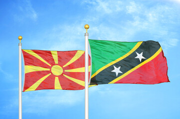 North Macedonia and Saint Kitts and Nevis two flags on flagpoles and blue sky