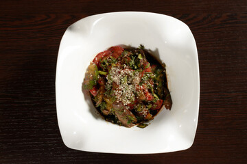 Delicious Korean salad sprinkled with sesame seeds, top view. Photos for restaurant and cafe menus