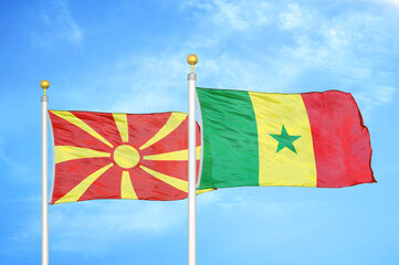 North Macedonia and Senegal two flags on flagpoles and blue sky