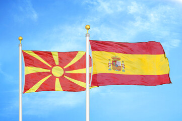 North Macedonia and Spain two flags on flagpoles and blue sky