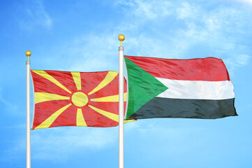 North Macedonia and Sudan two flags on flagpoles and blue sky