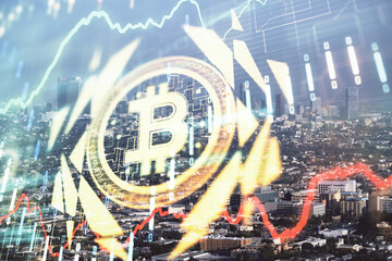 Double exposure of crypto currency theme hologram drawing and city veiw background. Concept of blockchain and bitcoin.