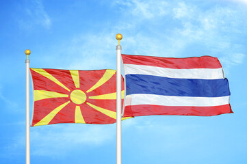North Macedonia and Thailand two flags on flagpoles and blue sky