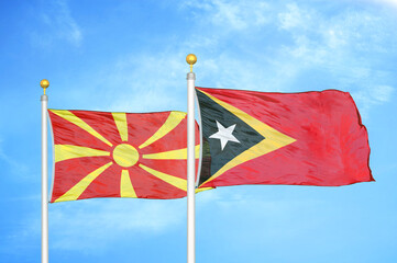 North Macedonia and Timor-Leste East Timor two flags on flagpoles and blue sky