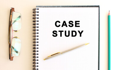 Notepad with text on a white background, near glasses and pencil. Business concept.