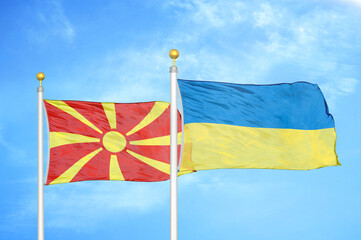 North Macedonia and Ukraine two flags on flagpoles and blue sky