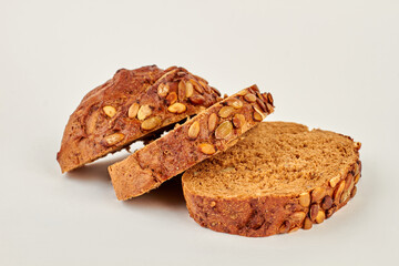 Bread slices on white background. Slices of wholegrain bread with pumpkin seeds. Delicious homemade food.