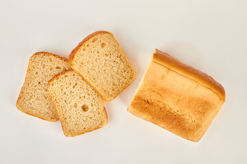 Sliced bread on white background. Cutted square bread, top view. Food concept.