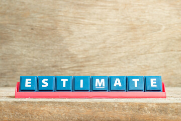 Tile letter on red rack in word estimate on wood background