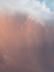 Rain clouds with rain at sunset.