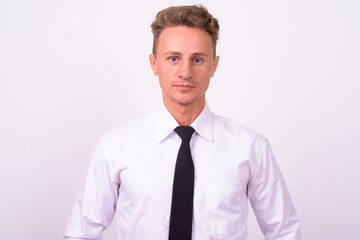 Handsome businessman with blond curly hair against white background