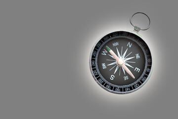 round compass on abstract gray background as symbol of tourism with compass, travel with compass and outdoor activities with compass