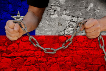 male hands break the iron chain, a symbol of bondage,protest against the background of the national...