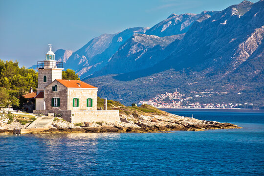 Lighthouse of Sucuraj on Hvar island and Biokovo mountain background view
