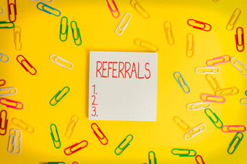 Writing note showing Referrals. Business concept for act, action, or an instance of referring to...