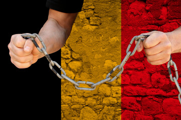 male hands break the iron chain, a symbol of bondage,protest against the background of the national...