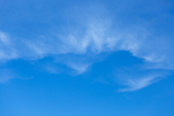 Blue sky background with tiny clouds.